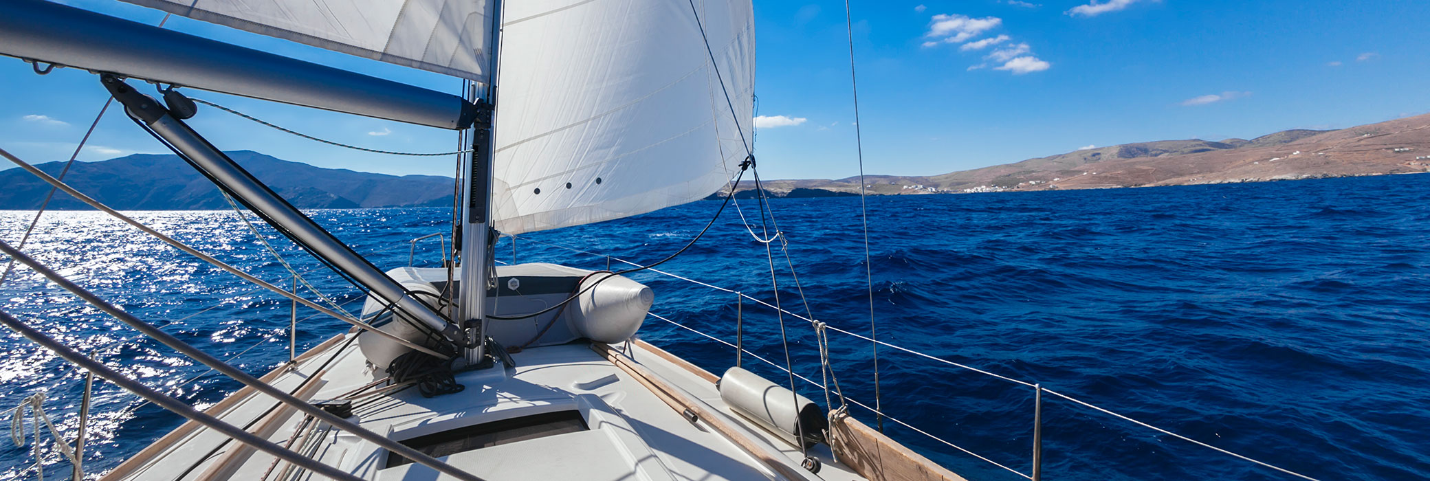 A sailingboat on the open water with blue sky